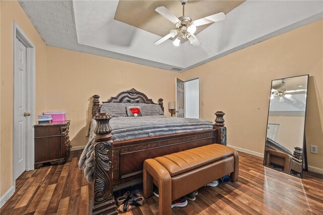 1230 Brook Meadow Ct, Lawrenceville, GA 30045 - bedroom with baseboards, wood finished floors, a ceiling fan, and a raised ceiling