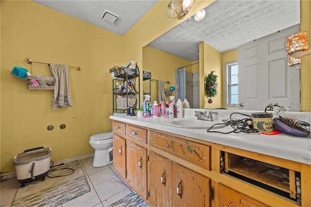 1230 Brook Meadow Ct, Lawrenceville, GA 30045 - bathroom with a shower stall, a textured ceiling, toilet, tile patterned flooring, and vanity