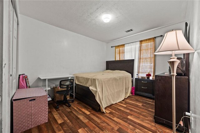 1230 Brook Meadow Ct, Lawrenceville, GA 30045 - bedroom featuring a textured ceiling and wood finished floors