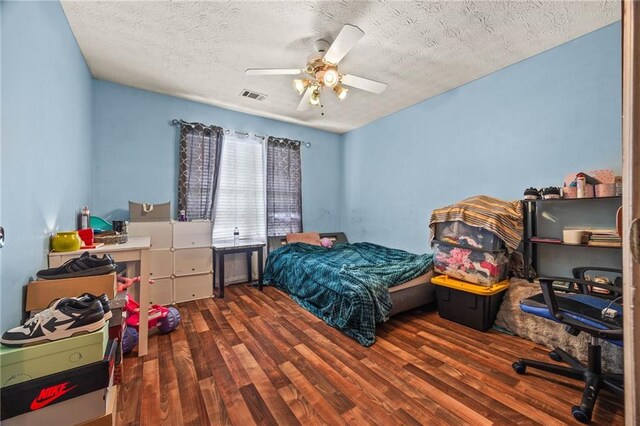1230 Brook Meadow Ct, Lawrenceville, GA 30045 - bedroom with wood finished floors, a textured ceiling, a ceiling fan, and an office area