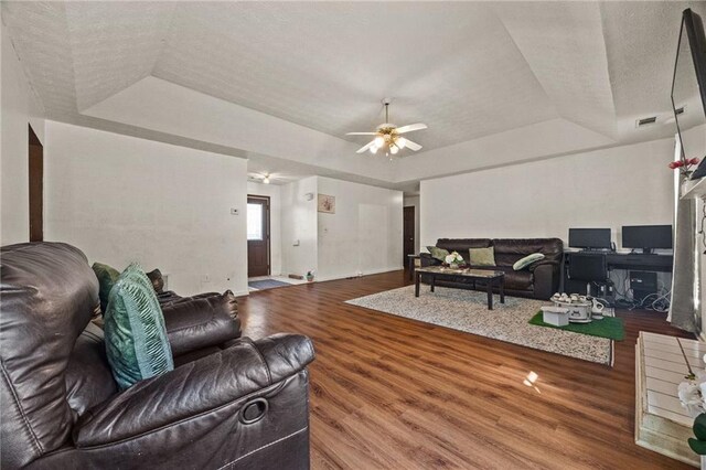 1230 Brook Meadow Ct, Lawrenceville, GA 30045 - living room featuring a raised ceiling, a ceiling fan, wood finished floors, baseboards, and a textured ceiling