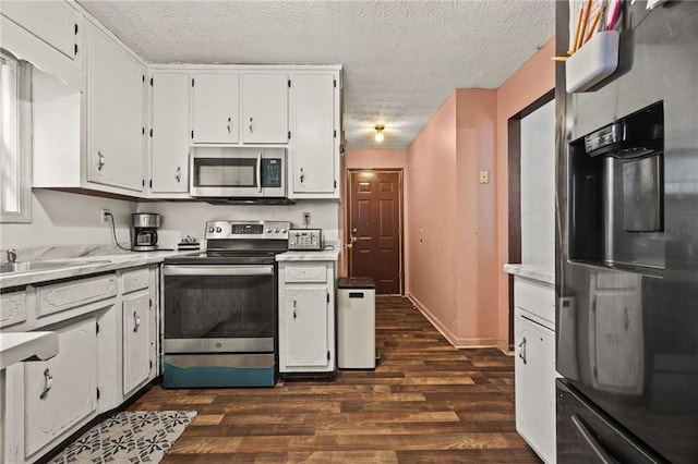 1230 Brook Meadow Ct, Lawrenceville, GA 30045 - kitchen featuring stainless steel appliances, dark wood-style floors, white cabinetry, light countertops, and a textured ceiling