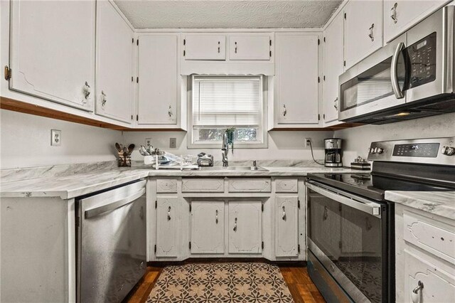 1230 Brook Meadow Ct, Lawrenceville, GA 30045 - kitchen with stainless steel appliances, a sink, light countertops, and dark wood-type flooring