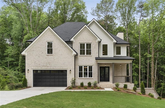 3915 Ashley Trace Ct SW, Lilburn, GA 30047 - view of front of house featuring concrete driveway, covered porch, an attached garage, a front lawn, and brick siding