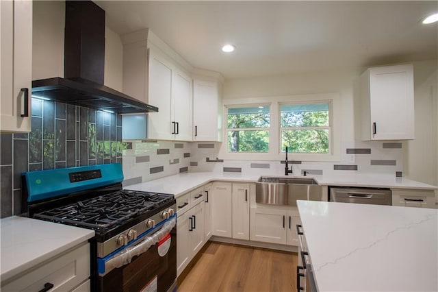 1342 Carter Rd, Decatur, GA 30030 - kitchen with stainless steel appliances, wall chimney range hood, a sink, light stone countertops, and white cabinetry