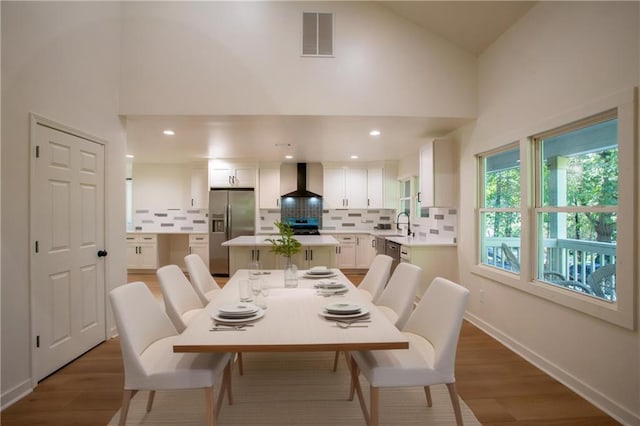 1342 Carter Rd, Decatur, GA 30030 - dining space with high vaulted ceiling, light wood-style floors, and baseboards