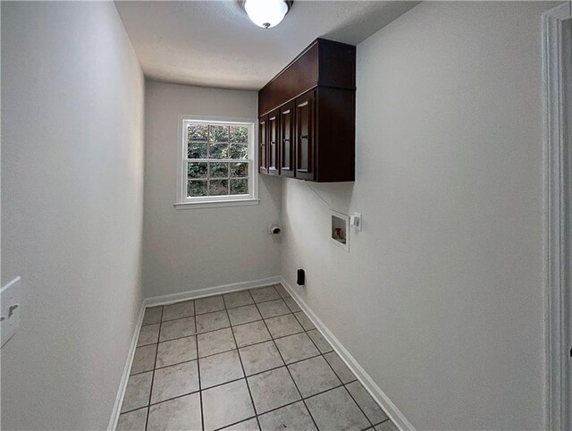 laundry room featuring washer hookup, hookup for an electric dryer, cabinets, and light tile patterned floors