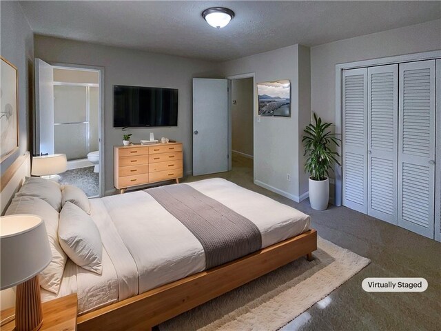 bedroom featuring ensuite bath, a closet, and a textured ceiling