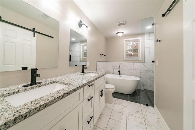 bathroom with a washtub, vanity, tile walls, and toilet