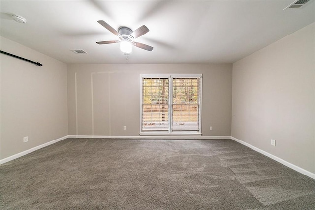 spare room featuring ceiling fan and carpet floors