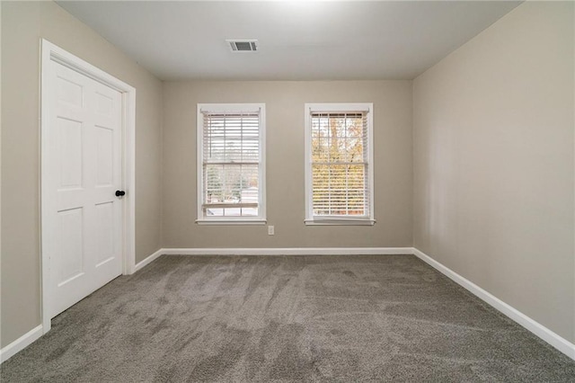 unfurnished room featuring carpet