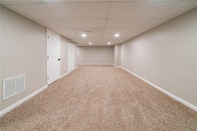 basement with carpet and a drop ceiling