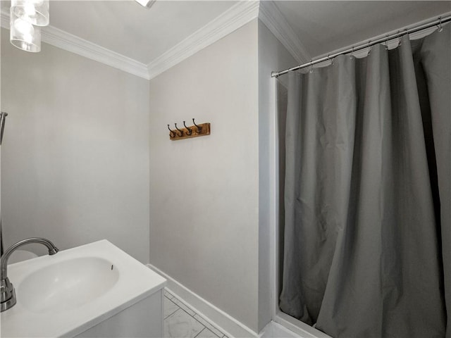 bathroom featuring ornamental molding and sink