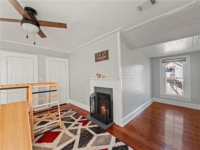 living room with ceiling fan, dark hardwood / wood-style flooring, and vaulted ceiling