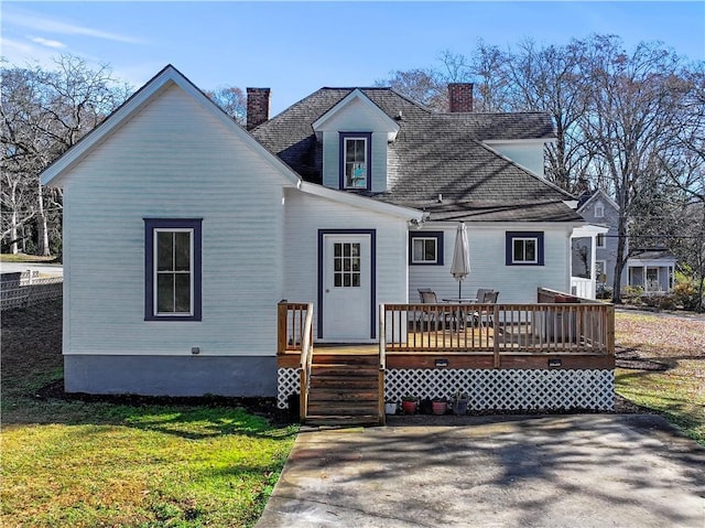 back of house featuring a yard and a wooden deck