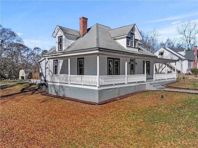 view of front of house with a porch and a front yard