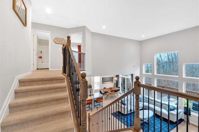 stairway with recessed lighting and baseboards