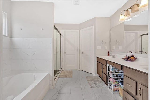 full bathroom featuring a garden tub, double vanity, marble finish floor, and a stall shower