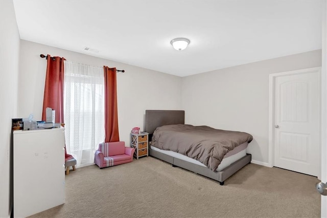 bedroom with carpet flooring, baseboards, and visible vents