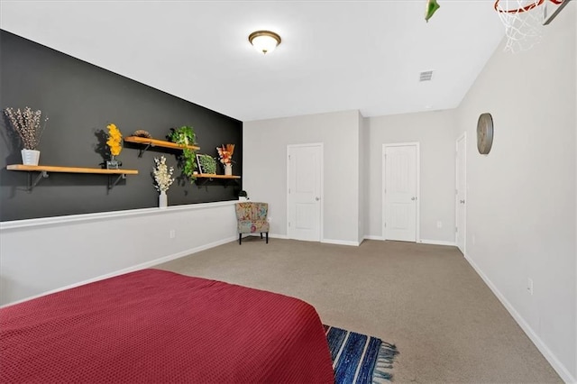 bedroom featuring visible vents, baseboards, and carpet