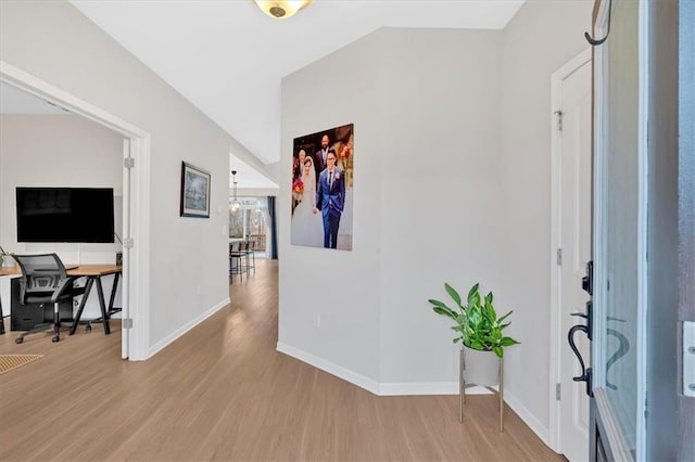 foyer featuring baseboards and light wood-type flooring