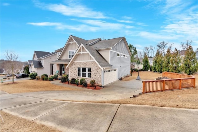 view of front of property featuring fence, an attached garage, concrete driveway, board and batten siding, and brick siding