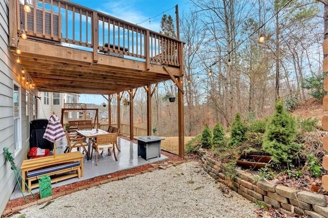 view of patio / terrace with outdoor dining space and a wooden deck