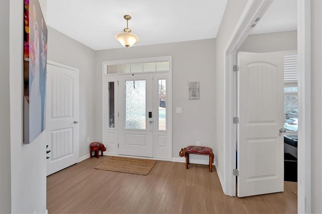 entrance foyer featuring light wood-style flooring and baseboards