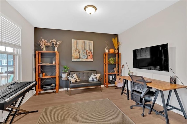 home office with baseboards and wood finished floors