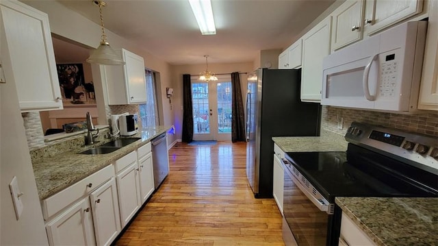 kitchen featuring sink, decorative light fixtures, white cabinets, and appliances with stainless steel finishes