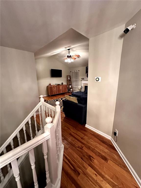 interior space featuring vaulted ceiling and dark hardwood / wood-style flooring