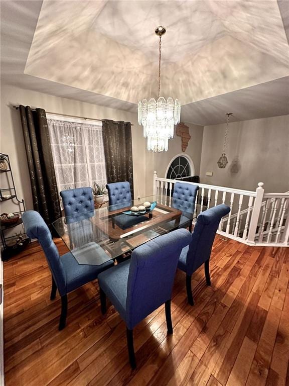 dining space featuring an inviting chandelier and hardwood / wood-style floors