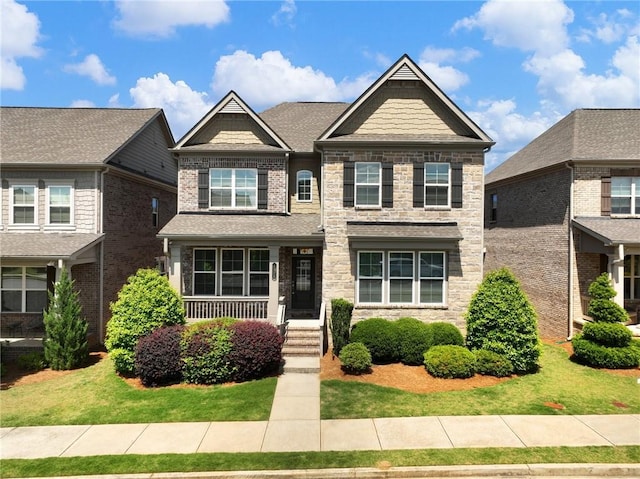 4905 Sterling Close, Buford, GA 30518 - craftsman house featuring stone siding and a front lawn