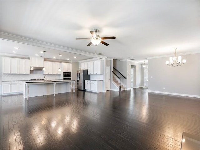4905 Sterling Close, Buford, GA 30518 - unfurnished living room with ornamental molding, a chandelier, a ceiling fan, dark wood-type flooring, and stairs