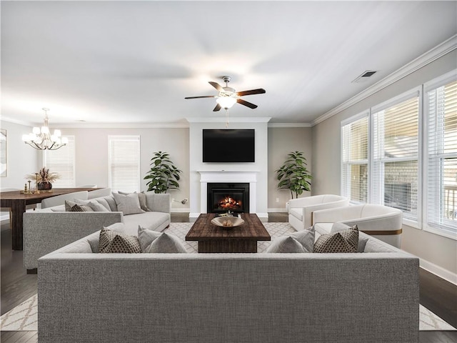 4905 Sterling Close, Buford, GA 30518 - living room with plenty of natural light, wood finished floors, a chandelier, a warm lit fireplace, and crown molding