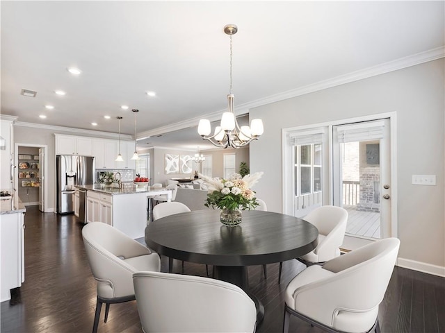 4905 Sterling Close, Buford, GA 30518 - dining area with a chandelier, crown molding, baseboards, recessed lighting, and dark wood-style floors