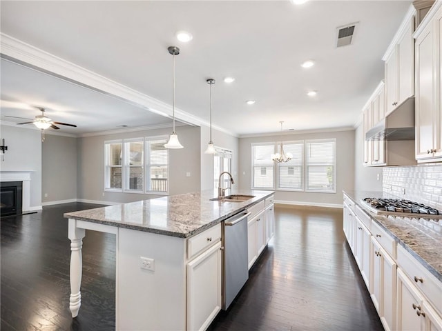 4905 Sterling Close, Buford, GA 30518 - kitchen featuring appliances with stainless steel finishes, under cabinet range hood, baseboards, a sink, and dark wood finished floors