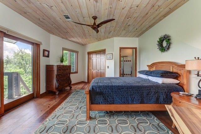 73 Falcon Heights Ln, Big Canoe, GA 30143 - bedroom with wood ceiling, wood finished floors, a ceiling fan, and a closet