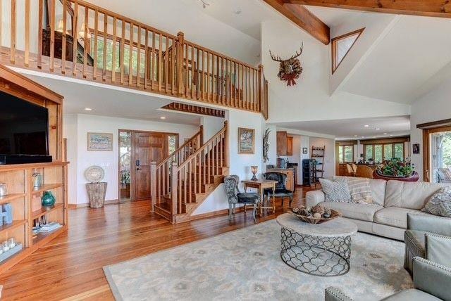 73 Falcon Heights Ln, Big Canoe, GA 30143 - living room with high vaulted ceiling, wood finished floors, and stairway