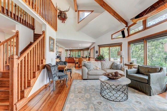 73 Falcon Heights Ln, Big Canoe, GA 30143 - living room featuring high vaulted ceiling, hardwood / wood-style floors, beamed ceiling, and stairway