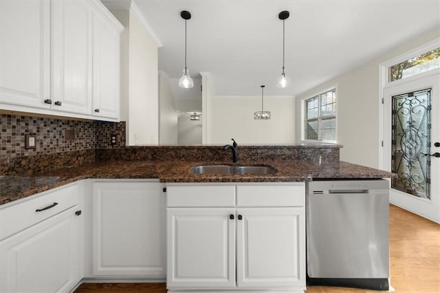 kitchen with white cabinetry, stainless steel dishwasher, and dark stone counters