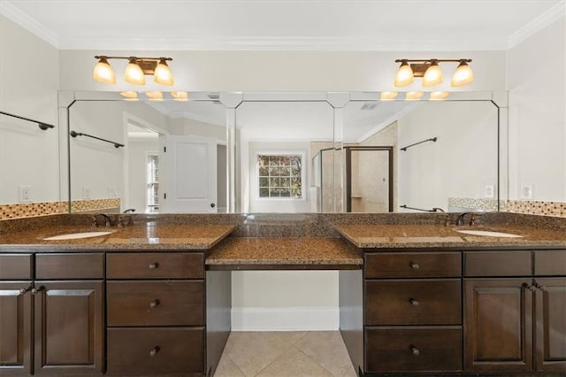 bathroom with tile patterned flooring, vanity, a shower with shower door, and crown molding