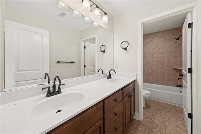 full bathroom featuring tile patterned floors, vanity, toilet, and tiled shower / bath