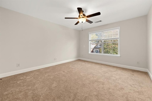 spare room with carpet and ceiling fan