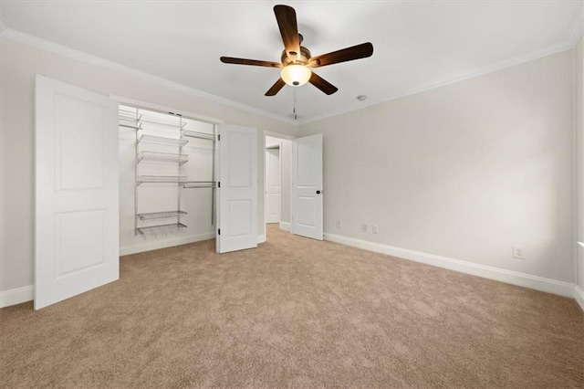 unfurnished bedroom featuring a closet, ceiling fan, crown molding, and light colored carpet