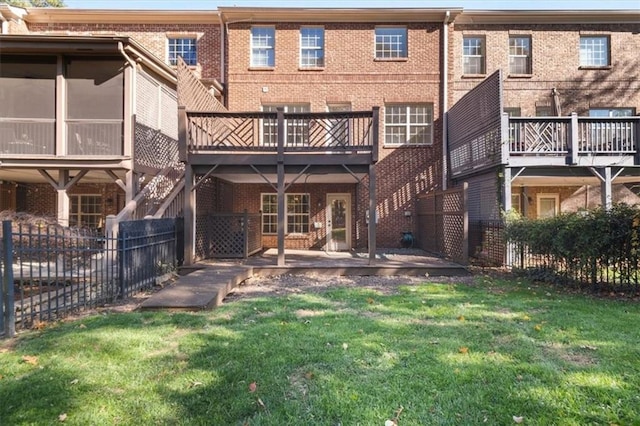 back of property with a yard and a patio