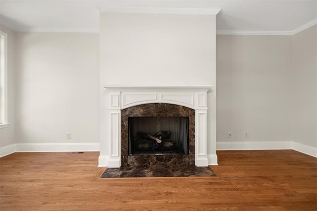 room details with crown molding, a fireplace, and hardwood / wood-style floors