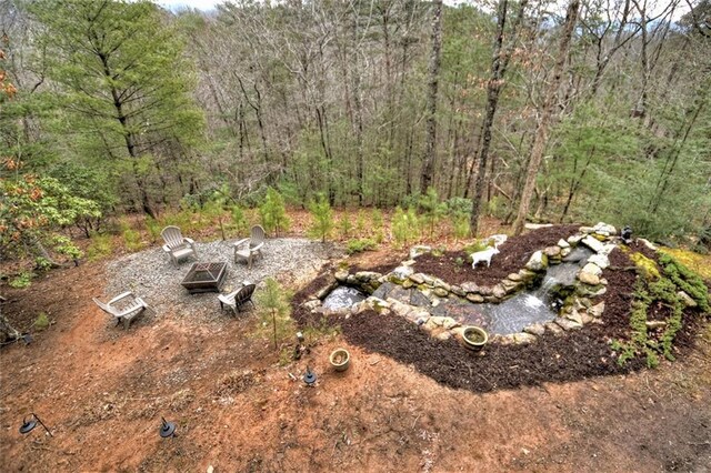 97 Doyle Carder Pkwy, Blue Ridge, GA 30513 - view of yard with an outdoor fire pit and a view of trees