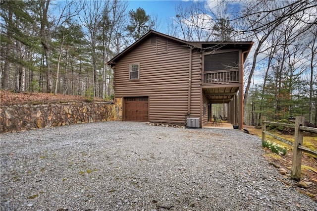 97 Doyle Carder Pkwy, Blue Ridge, GA 30513 - view of home's exterior featuring gravel driveway, a balcony, a garage, and central AC unit