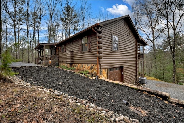 97 Doyle Carder Pkwy, Blue Ridge, GA 30513 - view of home's exterior with cooling unit, driveway, an attached garage, and log siding